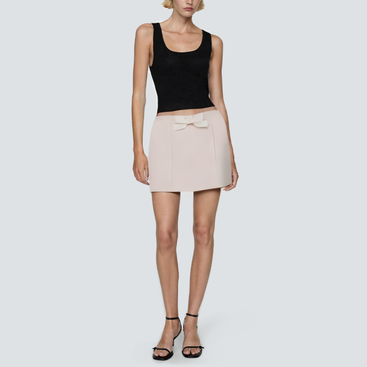 Beige women's short skirt with bow on front
